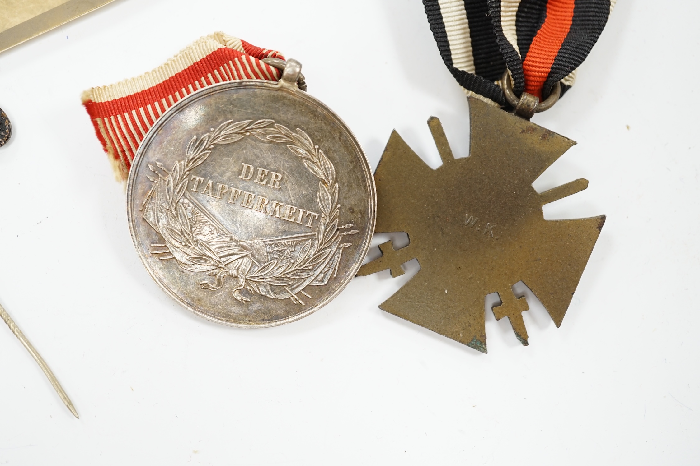 Four First World War German medals; a First Class Iron Cross, a 2nd Class Iron Cross, a 1914-1918 Honour Cross and an Austro-Hungarian Medal for Bravery, together with a wound badge and the related stick pin for the meda